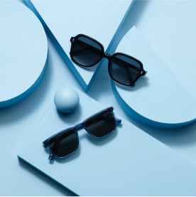Warby Parker sunglasses on a blue background
