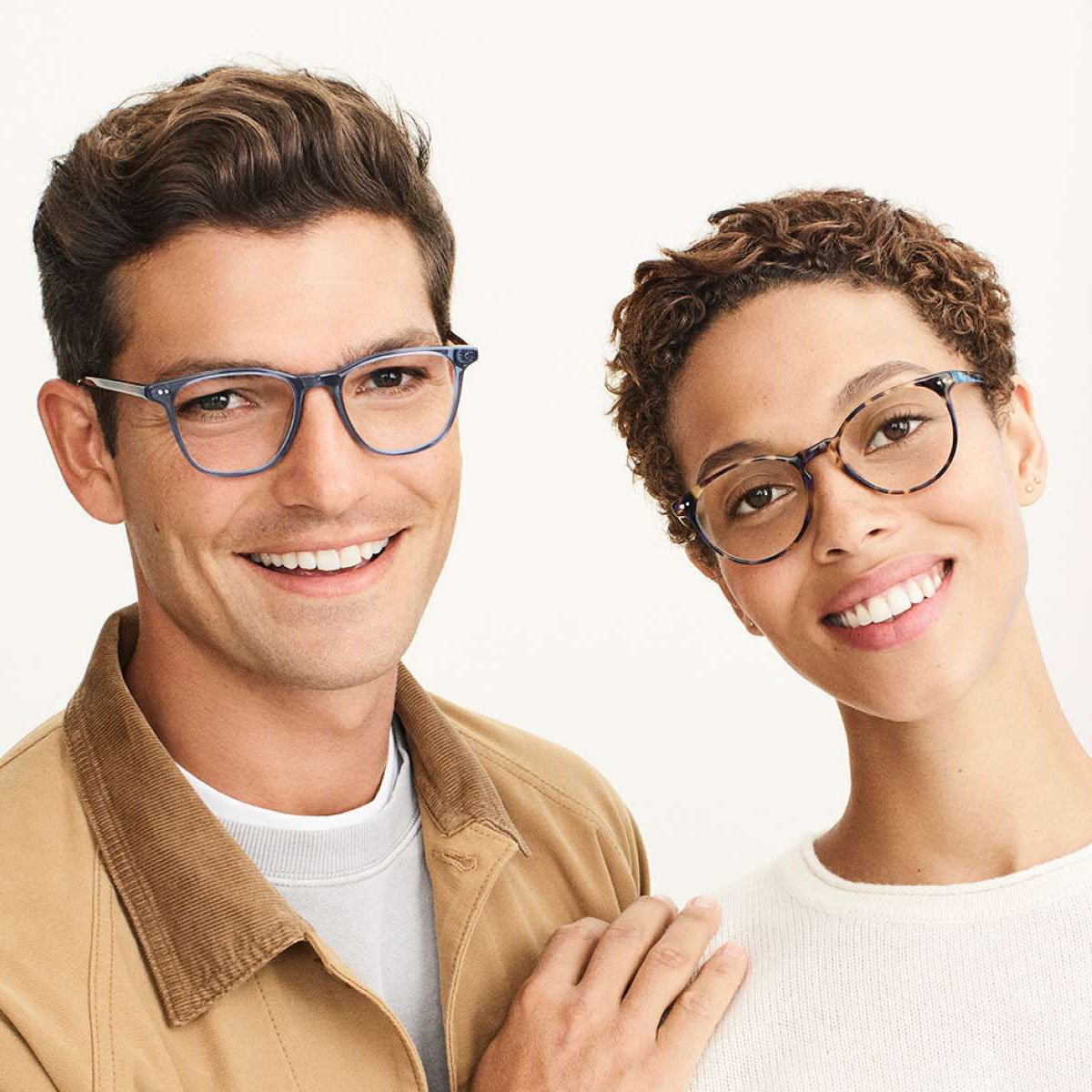 Smiling man and woman wearing glasses