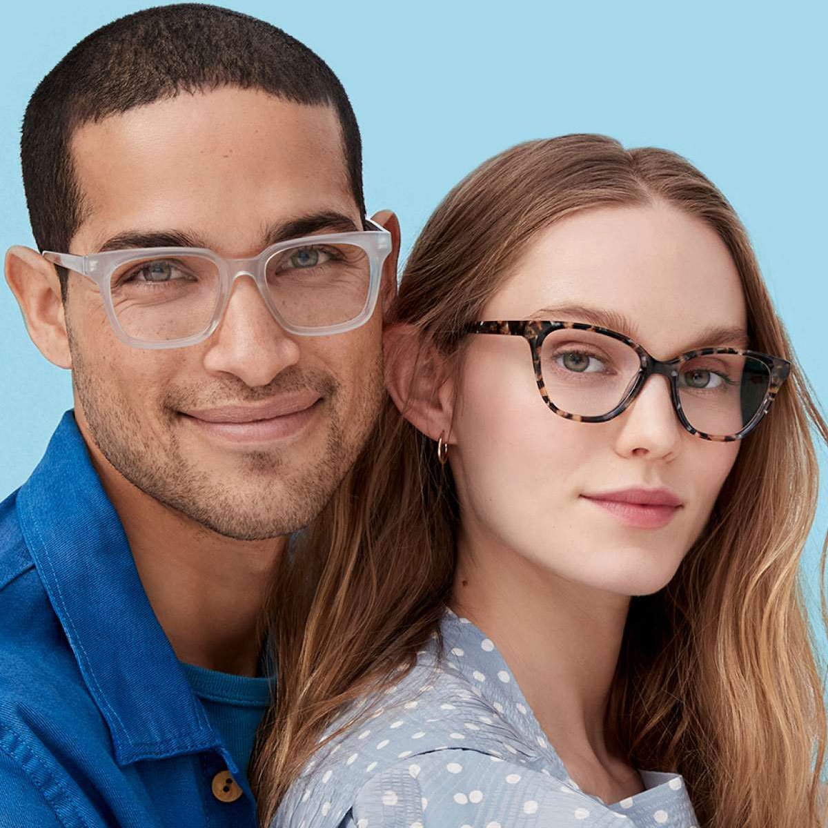 Man and woman wearing glasses against a blue background