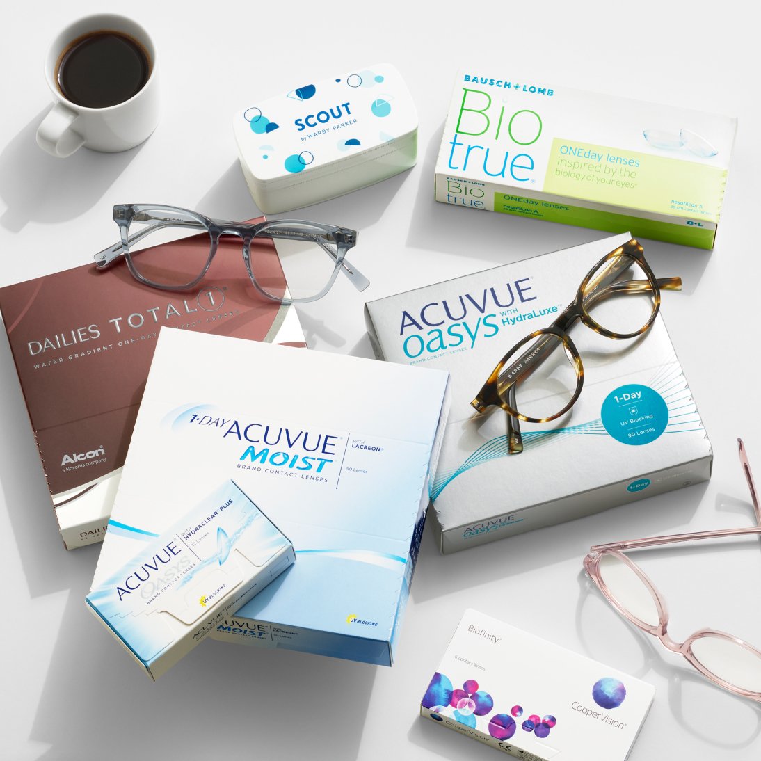 An array of prescription glasses and boxes of contact lenses