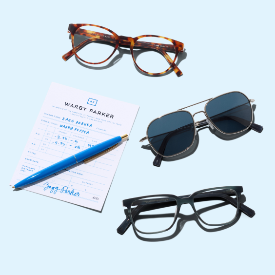 Three pairs of glasses next to a written eye prescription and pen