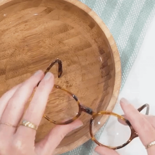 Gif of hands tightening glasses temples after dipping them in a bowl of water