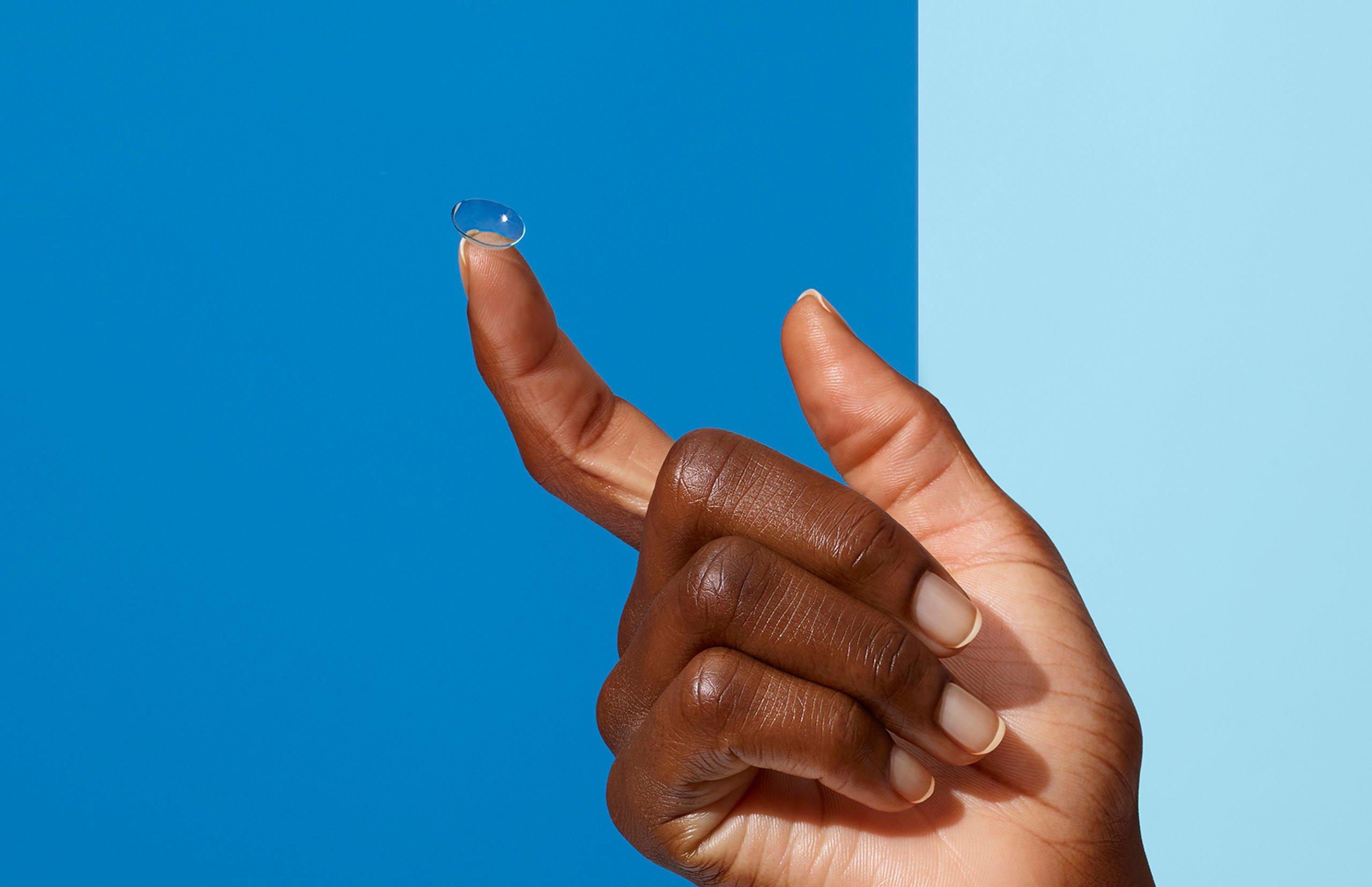 a contact lens on a finger