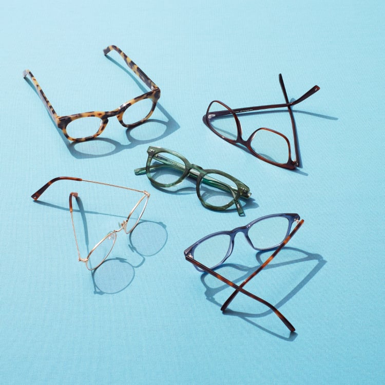 Five pairs of glasses on a light blue background