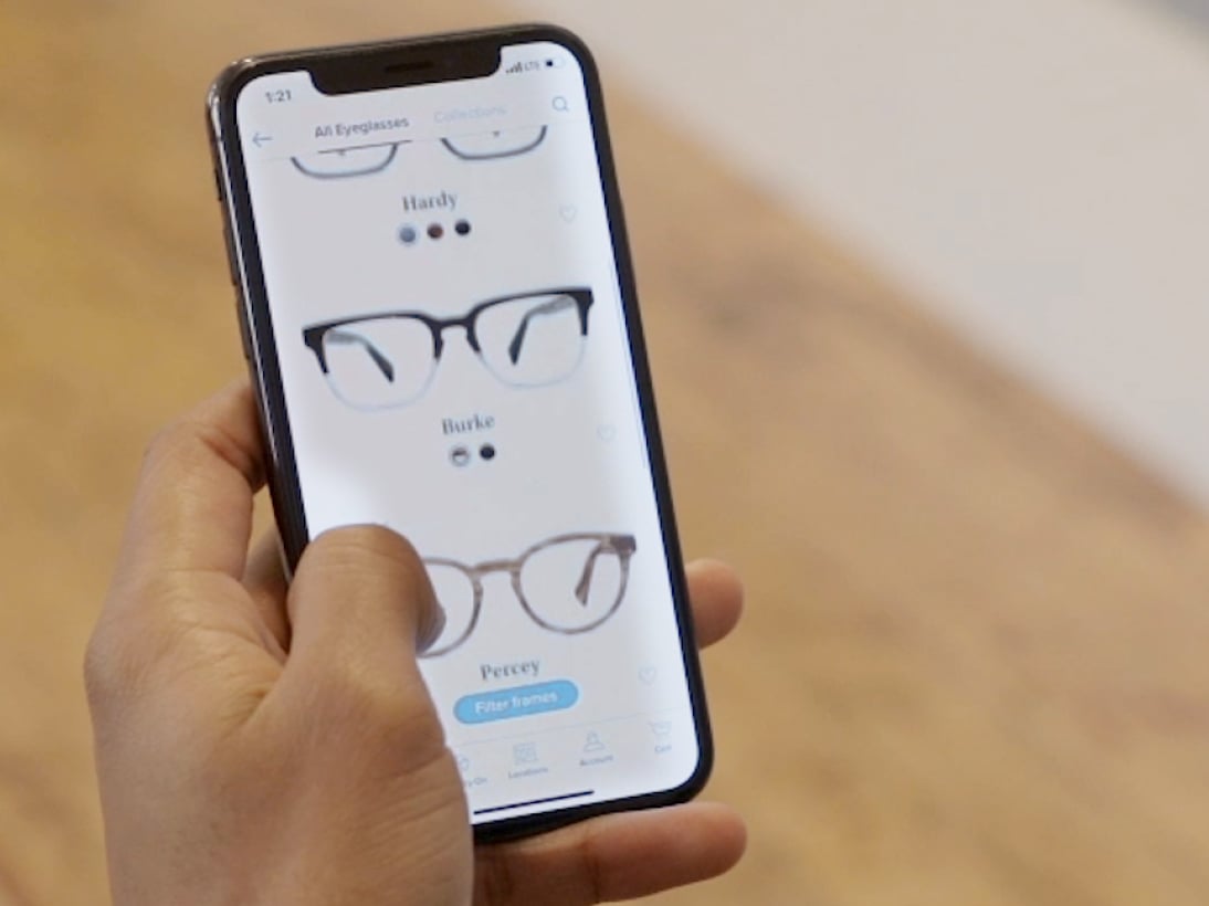 A smartphone showing glasses frames you can try on virtually