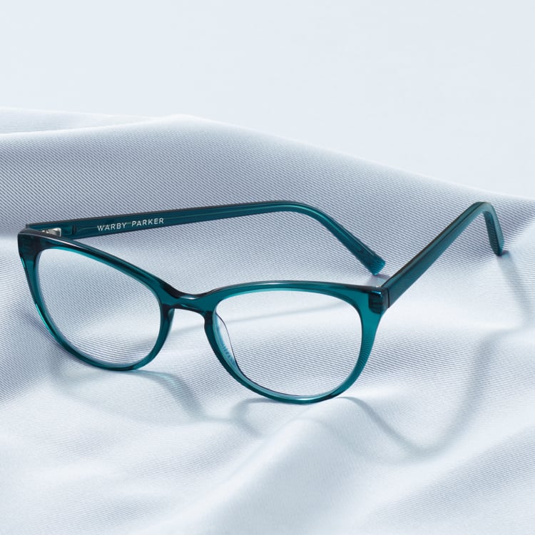 Turquoise eyeglasses on a clean cloth