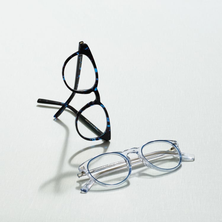 Two pairs of glasses, one with opaque and one with transparent frames
