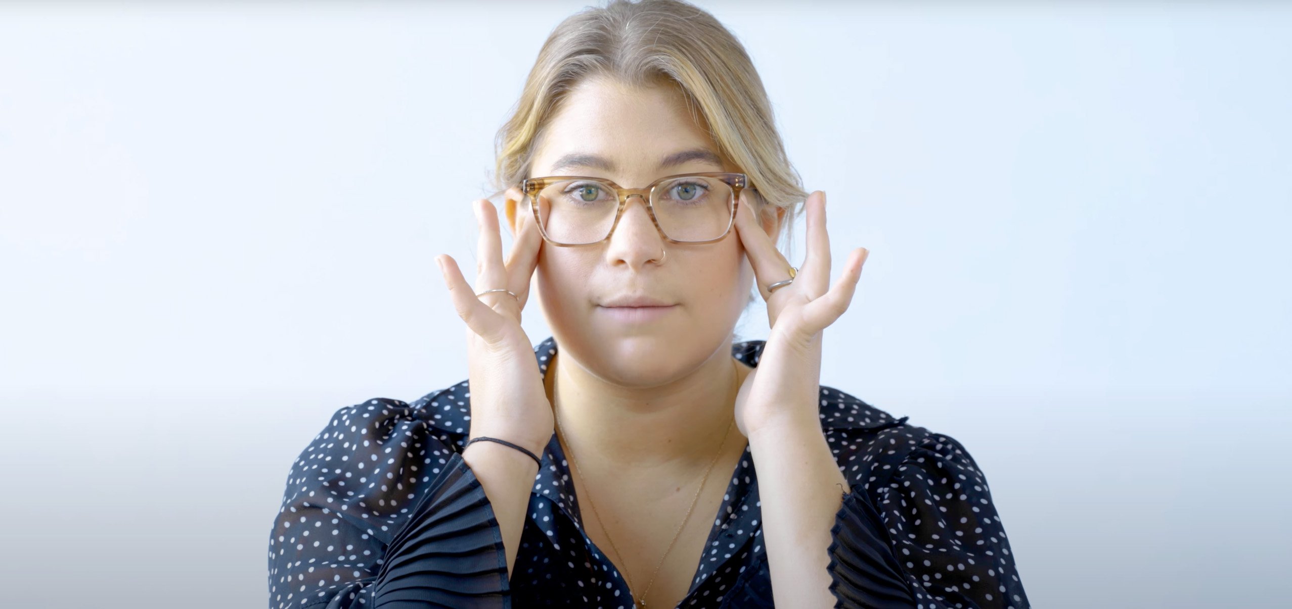 Woman considering the fit of her frames