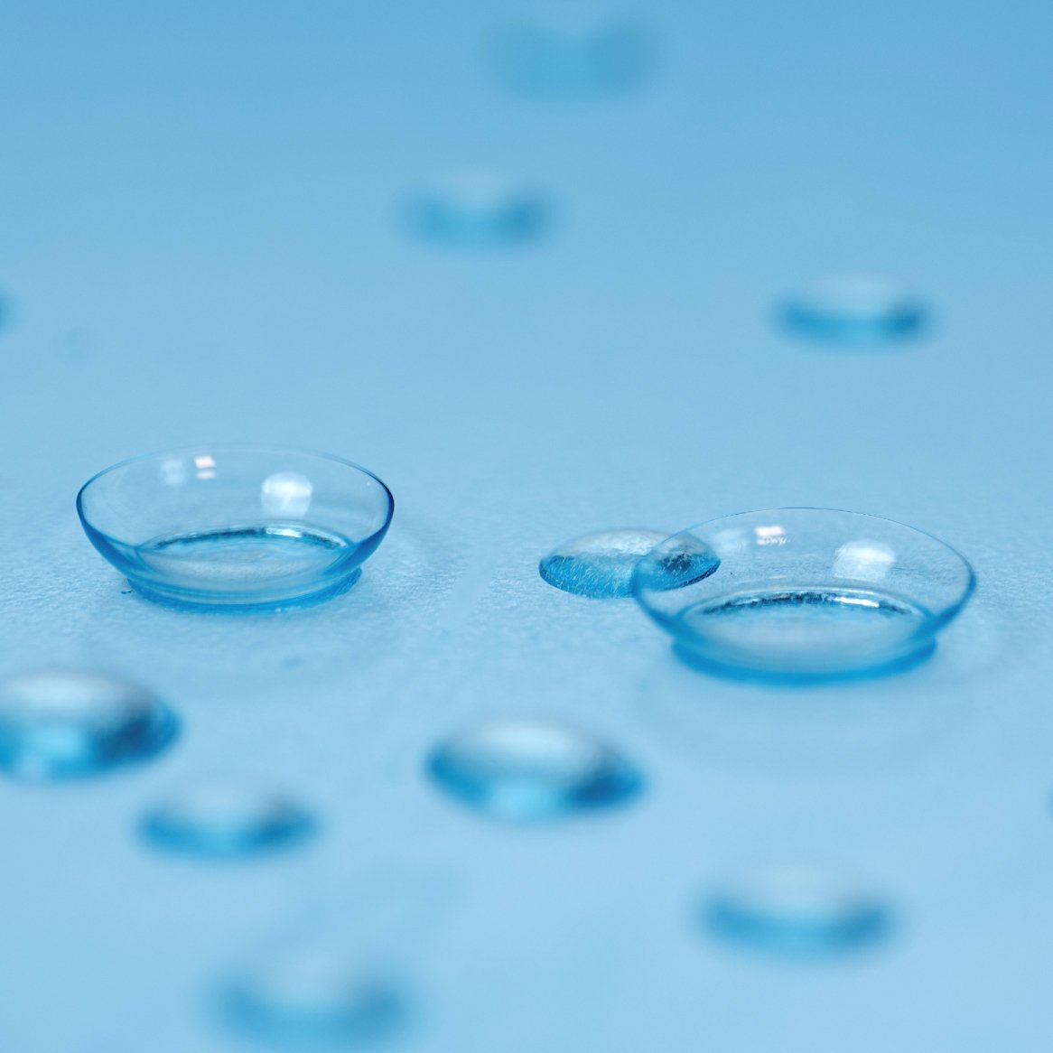 Close-up of contact lenses surrounded by water droplets