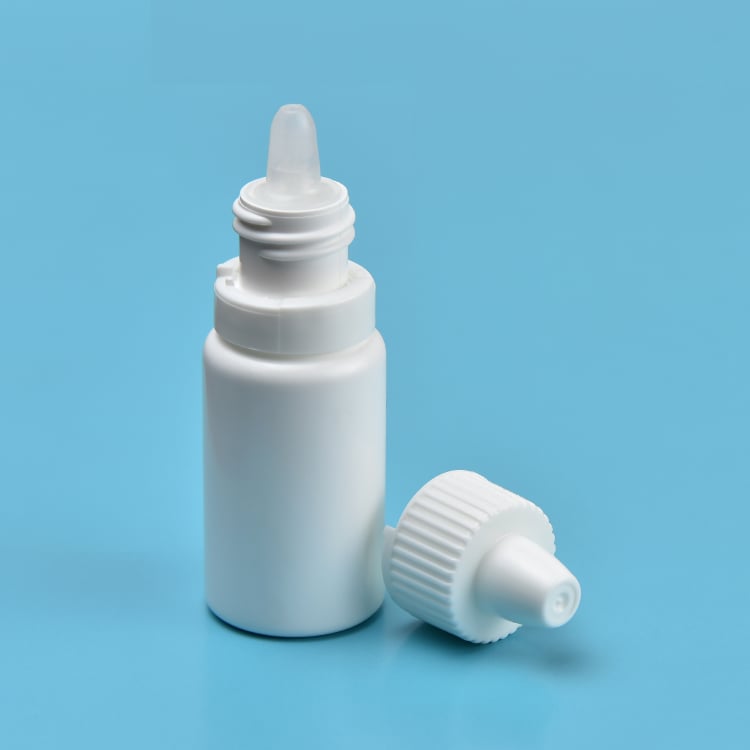 A white bottle of eye drops on a blue background