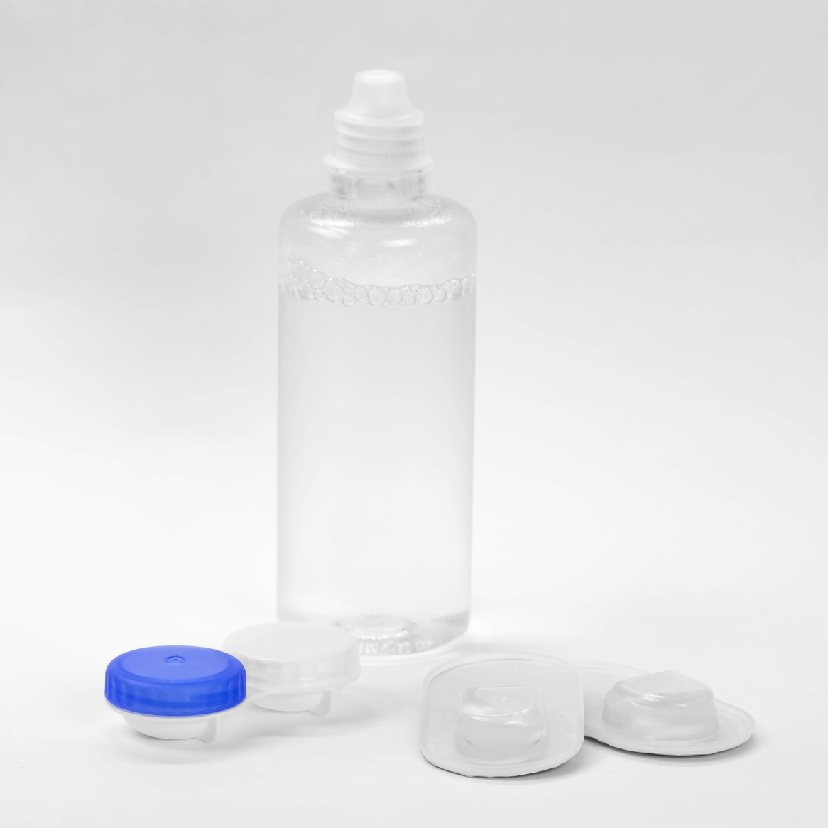 A contact solution bottle pictured with a contact storage case