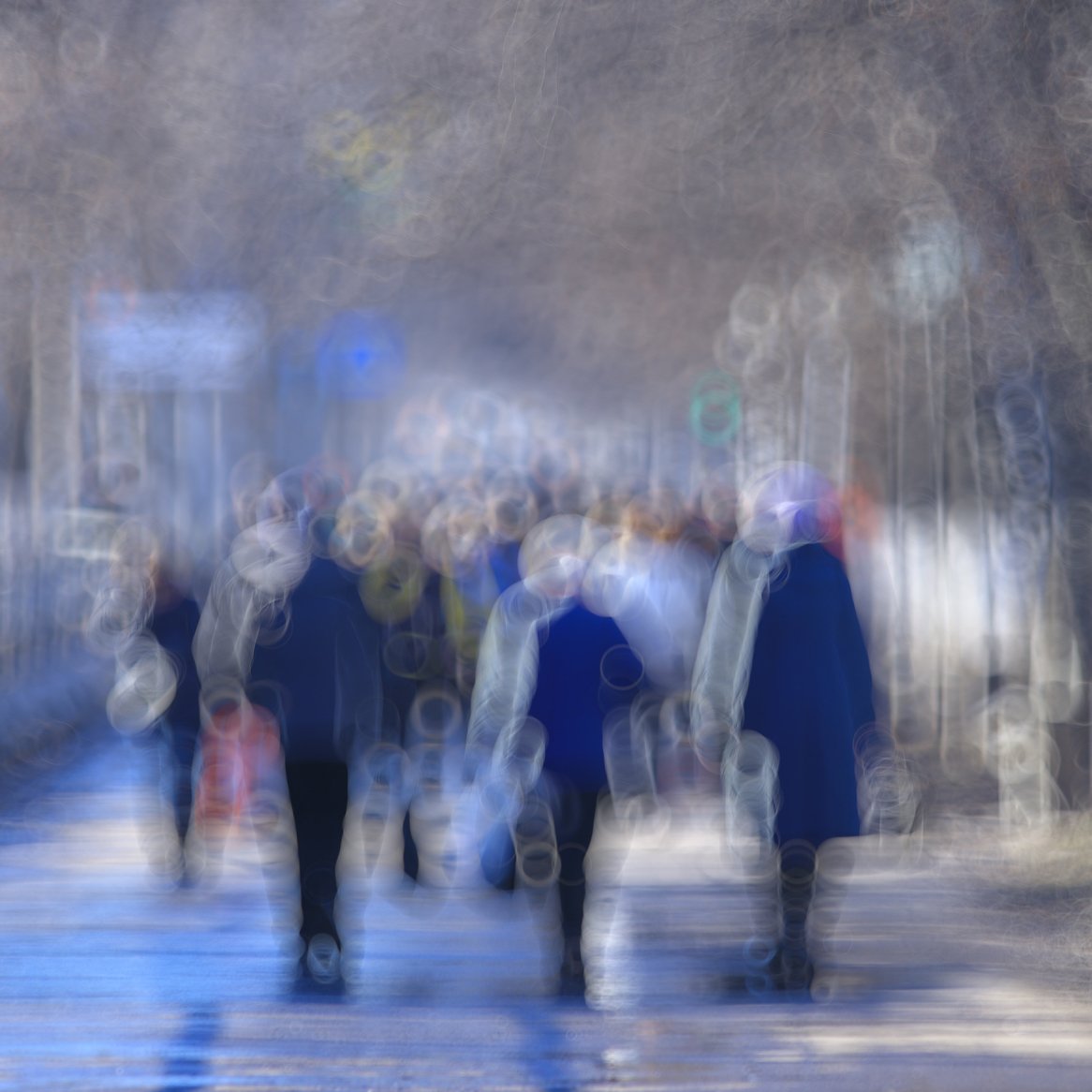 Blurred image of people walking down a road